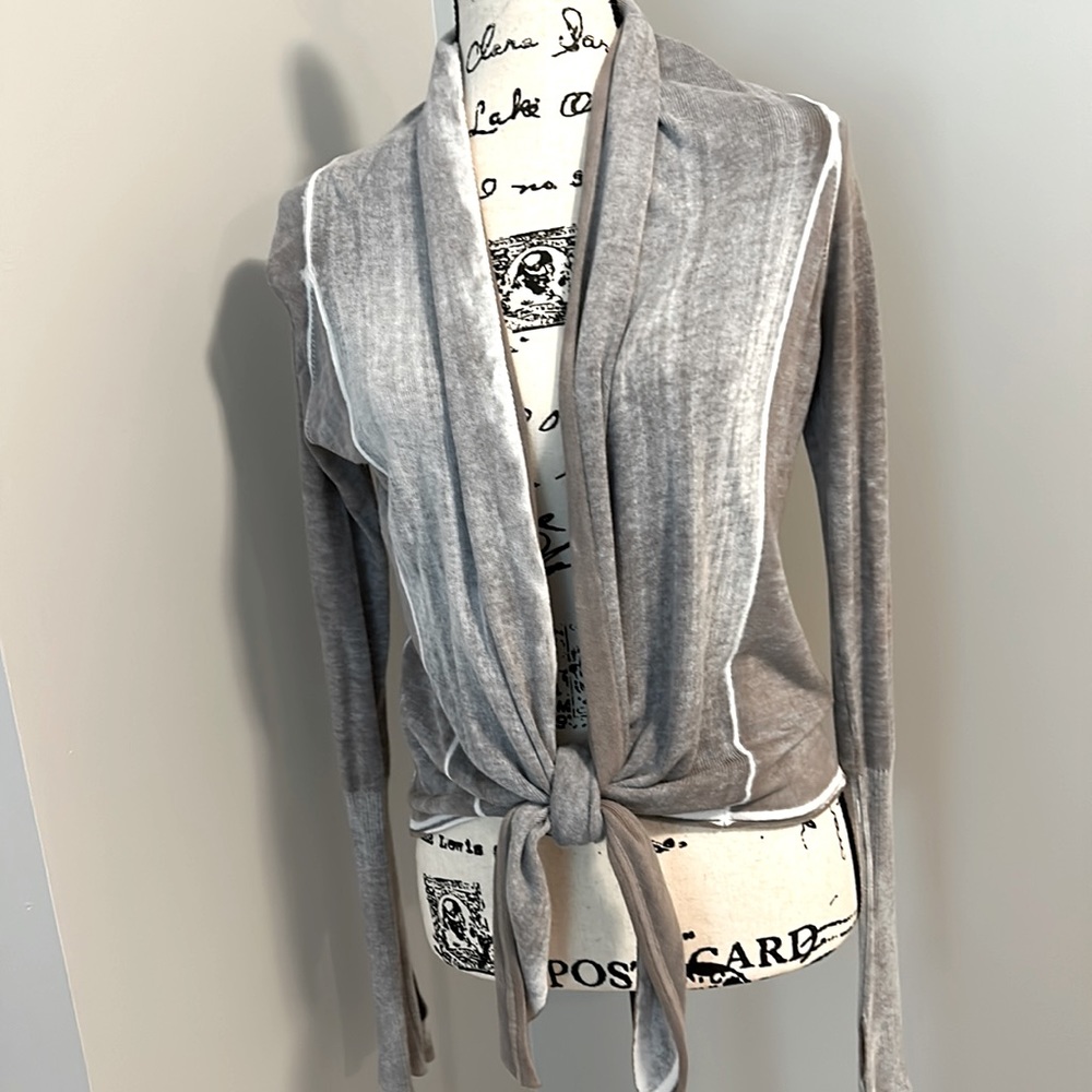Long sleeves and gracefully wrapped silhouette add unique styling to this top